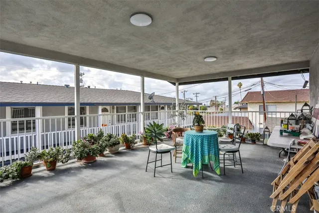 a view of a patio with chairs and plants