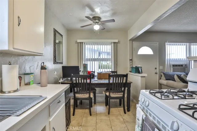 a view of a a dining room with furniture window and wooden floor