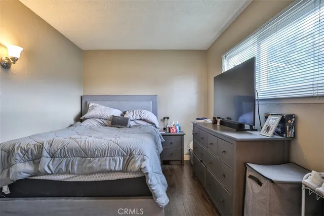 a bedroom with a bed and a desk