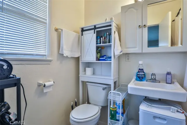 a white toilet sitting next to a bathroom sink