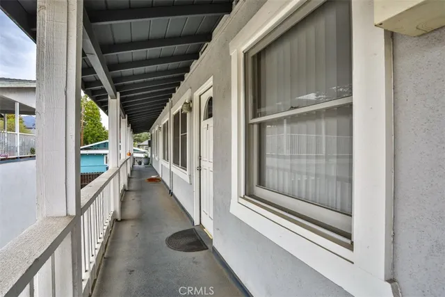 a view of staircase with railing and white walls