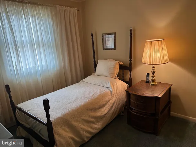 a bedroom with a bed and a table