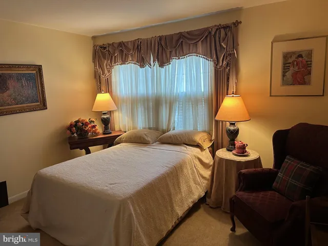 a bedroom with a bed and lamp