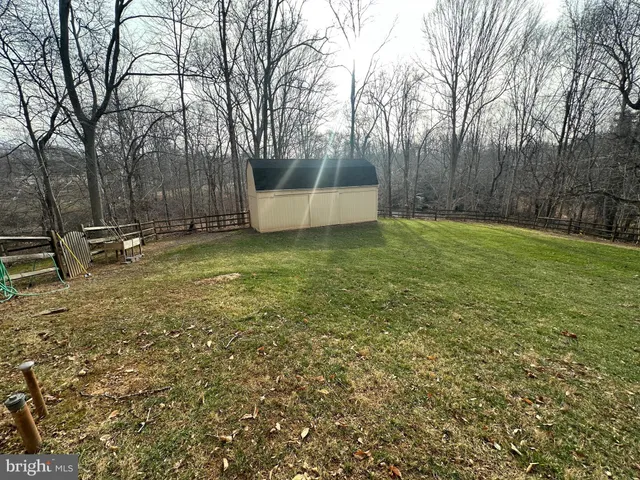 a view of a house with large trees