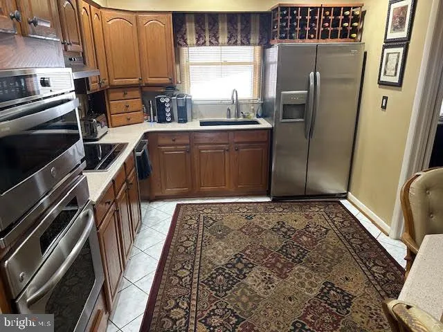 a kitchen with stainless steel appliances granite countertop a refrigerator and a stove