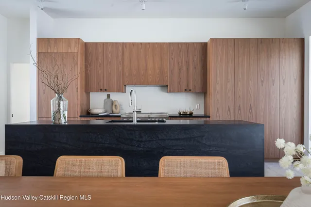 a kitchen with stainless steel appliances kitchen island granite countertop cabinets and sink