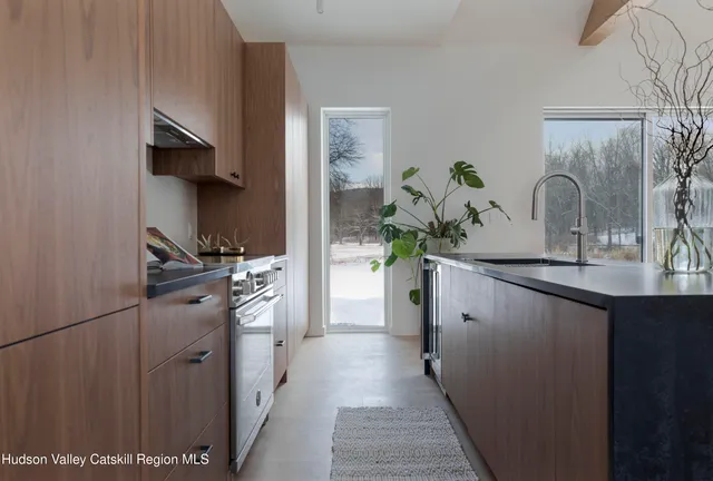 a kitchen with white cabinets and appliances