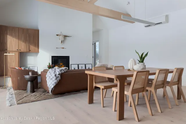 a living room with furniture a fireplace and a dining table