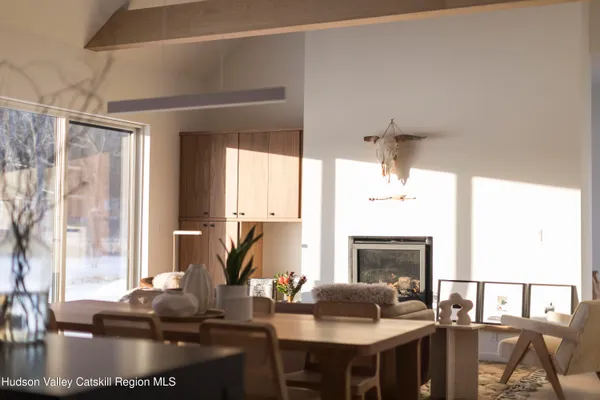 a living room with fireplace furniture and a large window