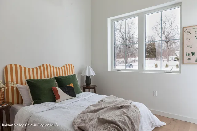 a bedroom with a bed and window