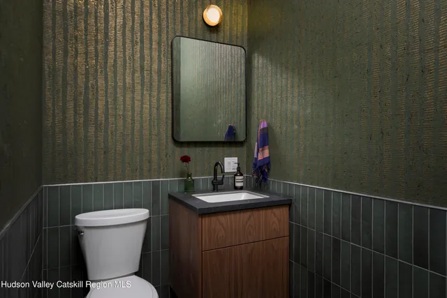 a bathroom with a toilet and a mirror