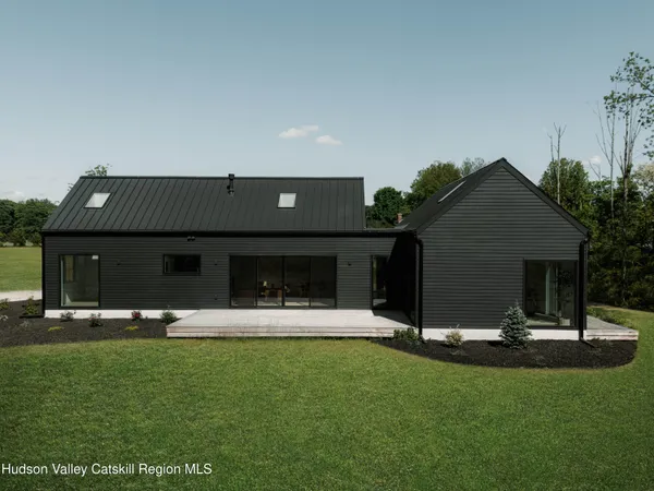 a view of a house with backyard and porch