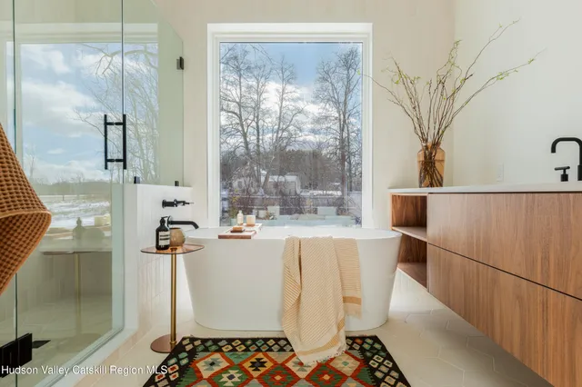 a very nice looking room with a large window with white walls