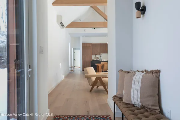 a hallway with a view of bathroom and mirror