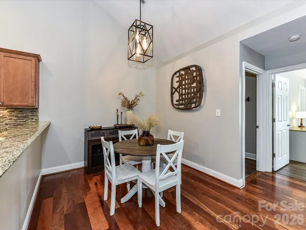 a view of a dining room with furniture wooden floor and a chandelier