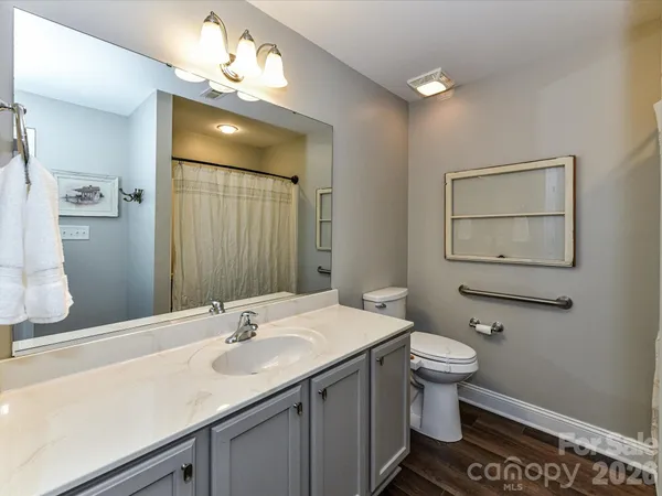 a bathroom with a sink a toilet and mirror