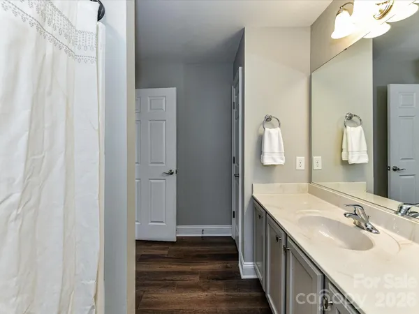 a bathroom with double vanity and a mirror