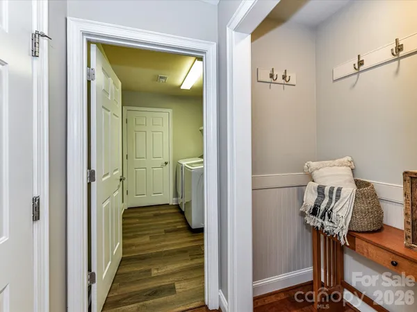 a view of a hallway with wooden floor and entryway