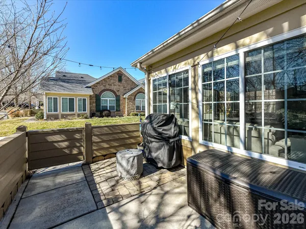a view of a patio with table and chairs and wooden fence