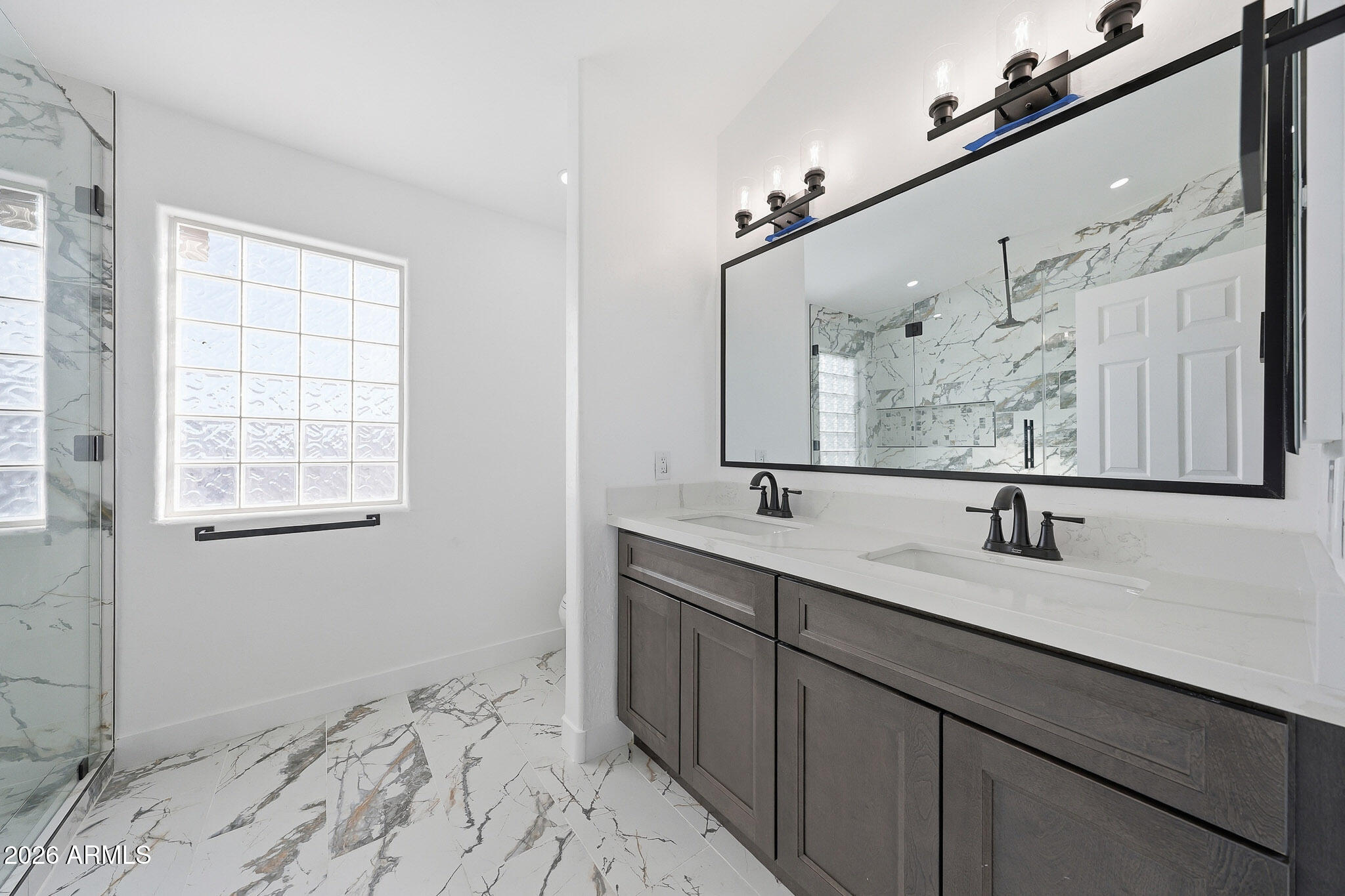 916 East Harwell Road Phoenix, AZ 85042 - Photo 12 of 27 a bathroom with a sink and a mirror