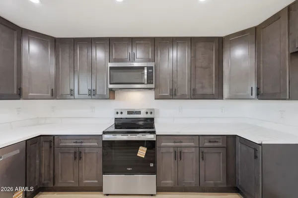 a kitchen with sink cabinets and stainless steel appliances