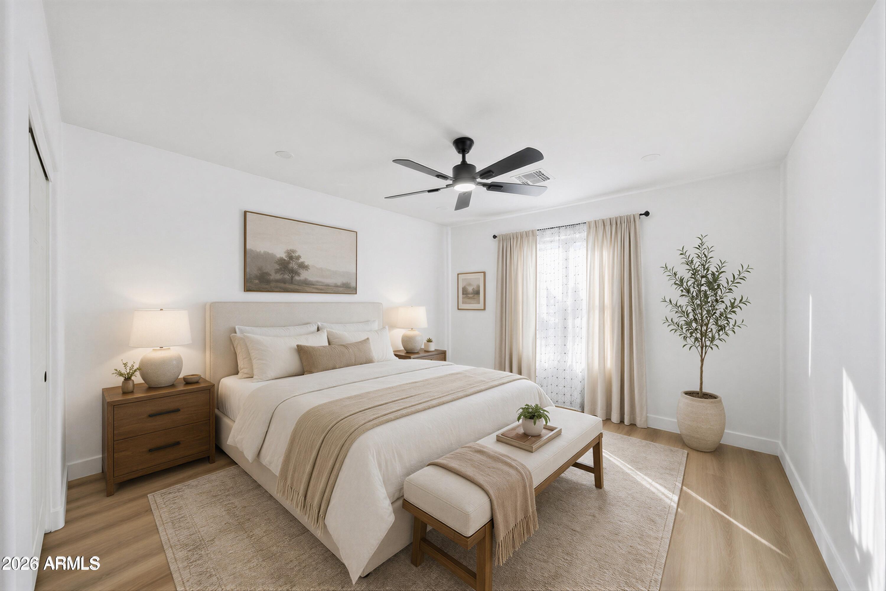 916 East Harwell Road Phoenix, AZ 85042 - Photo 14 of 27 a bedroom with a bed and a chandelier