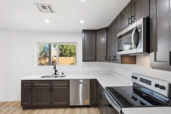 a kitchen with a sink stove and microwave