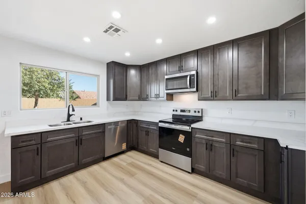 a kitchen with wooden cabinets and sink