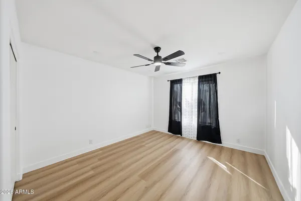 a view of an empty room with a ceiling fan