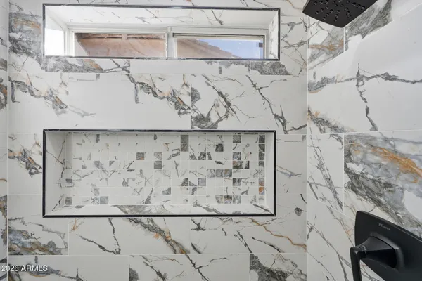 a bathroom with a bathtub and shower