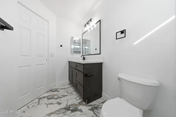 a bathroom with a toilet sink and mirror