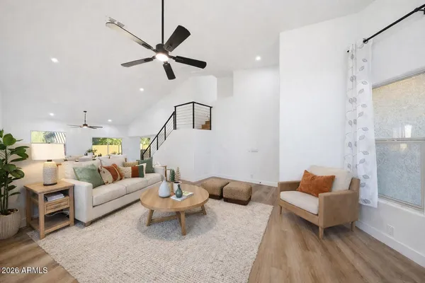 a living room with furniture and a ceiling fan