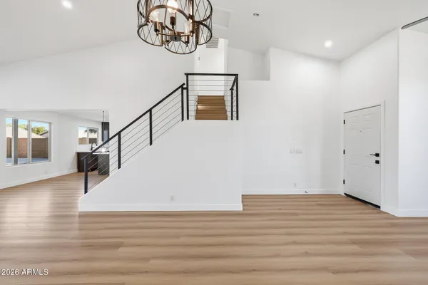 a view of entryway with stairs and wooden floor