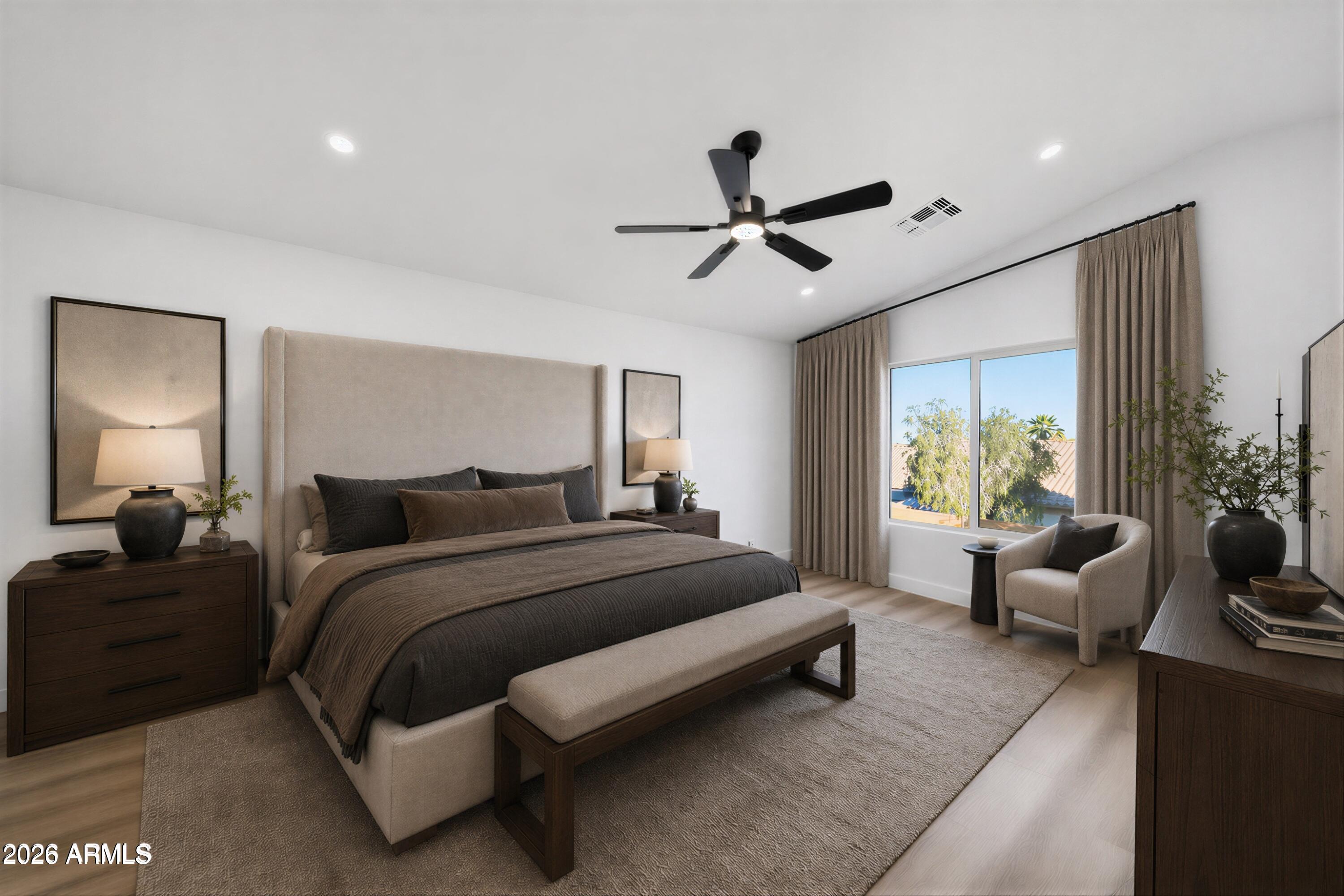 916 East Harwell Road Phoenix, AZ 85042 - Photo 10 of 27 a spacious bedroom with a bed a couch and a window