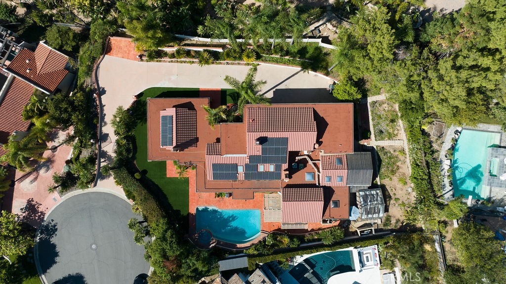 an aerial view of a house with yard swimming pool and outdoor seating