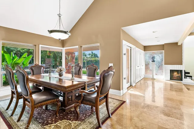 a dining room with furniture a chandelier and wooden floor