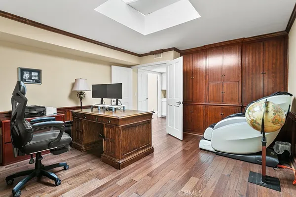 a view of a workspace with furniture and wooden floor