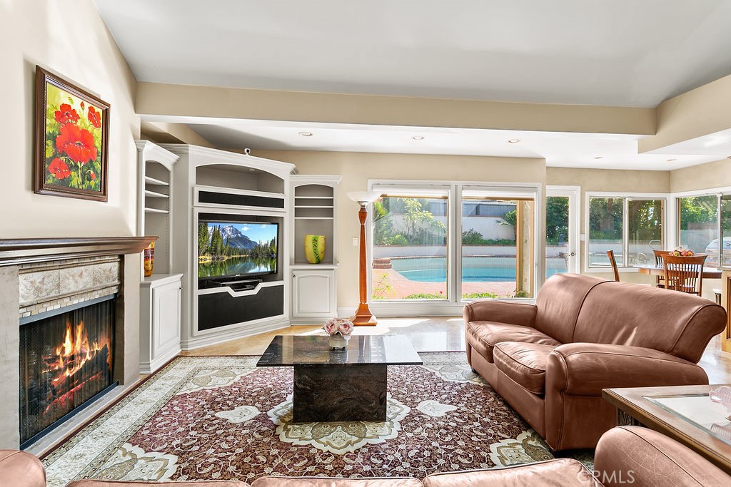 18811 Ridgeview Circle Villa Park, CA 92861 - Photo 21 of 34 a living room with furniture a floor to ceiling window and a fireplace