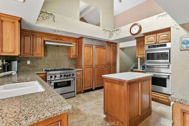 a kitchen with a stove and a refrigerator