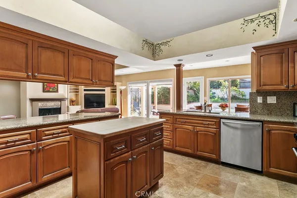a kitchen with stainless steel appliances granite countertop a stove a sink dishwasher and a microwave oven with cabinets