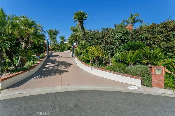 a view of a street with a flower garden