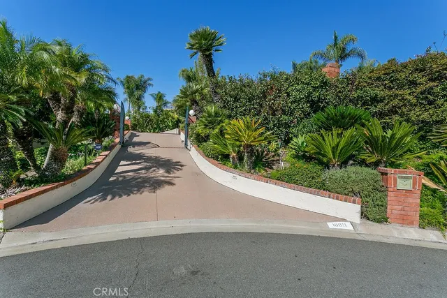 a view of a street with a flower garden