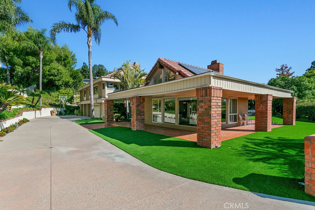 18811 Ridgeview Circle Villa Park, CA 92861 - Photo 4 of 34 a front view of a house with a yard and potted plants