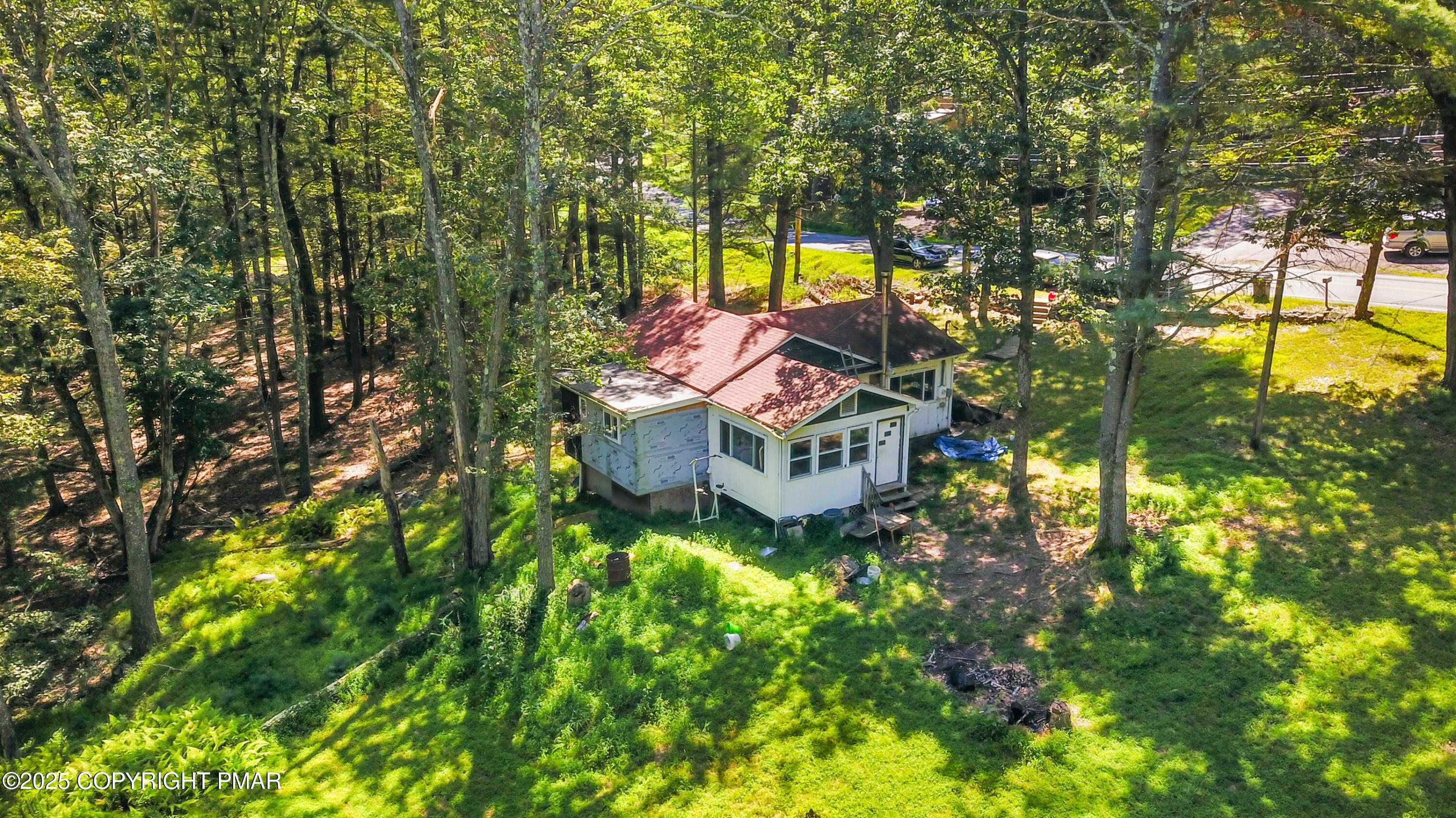 a view of a house with a big yard and large trees