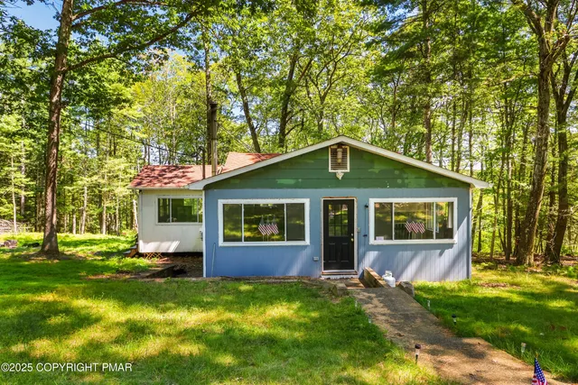 a front view of house with yard and green space