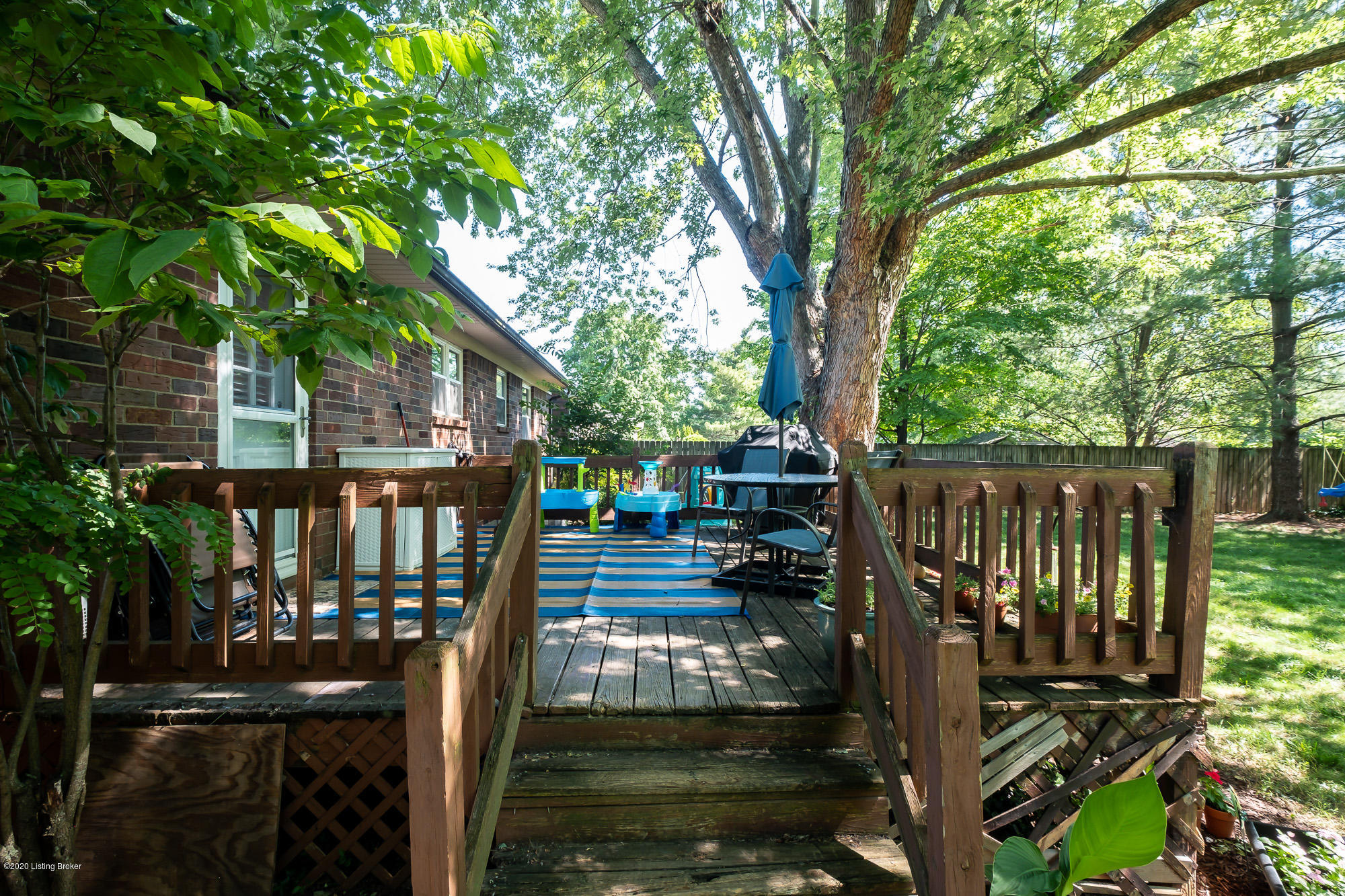 3705 Longview Road Louisville, KY 40299 - Photo 26 of 31 The rear deck adds so much living space to the home just outdoors! Mature trees provide shade and room for seating and outdoor furnishings is plentiful.
