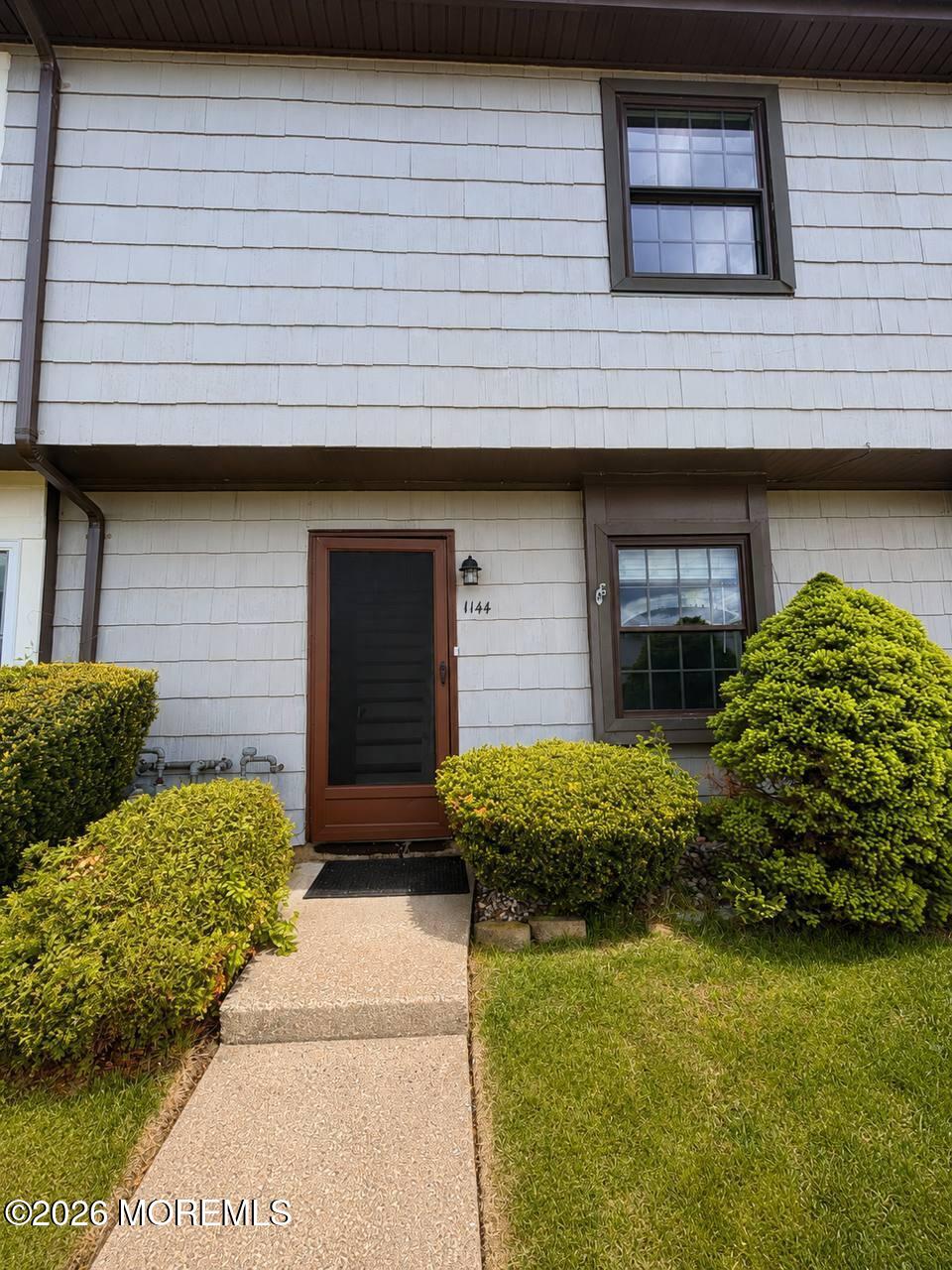 1144 Sawmill Road, Unit 121 Brick, NJ 08724 - Photo 2 of 23 a front view of a house with garden