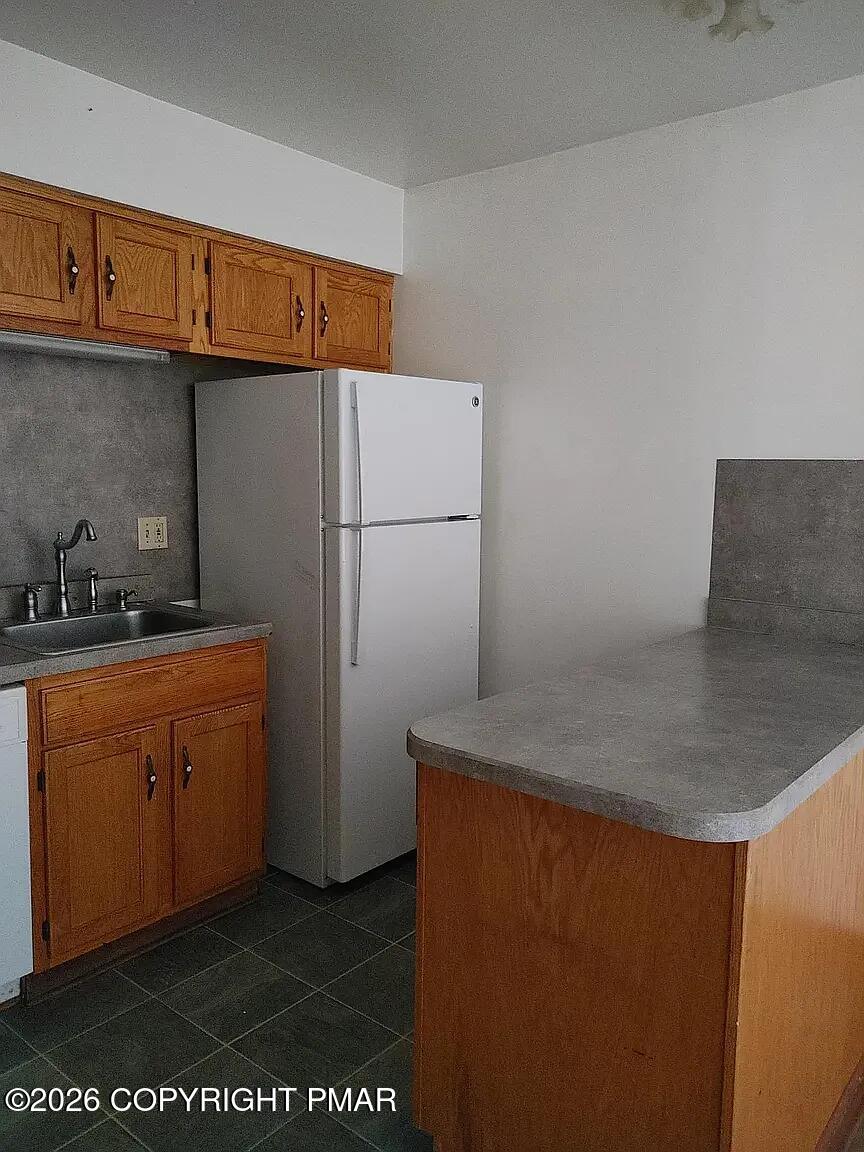 165 Old Stagecoach Road, Unit 3 Gilbert, PA 18331 - Photo 14 of 20 a kitchen with stainless steel appliances granite countertop a refrigerator a stove and a sink