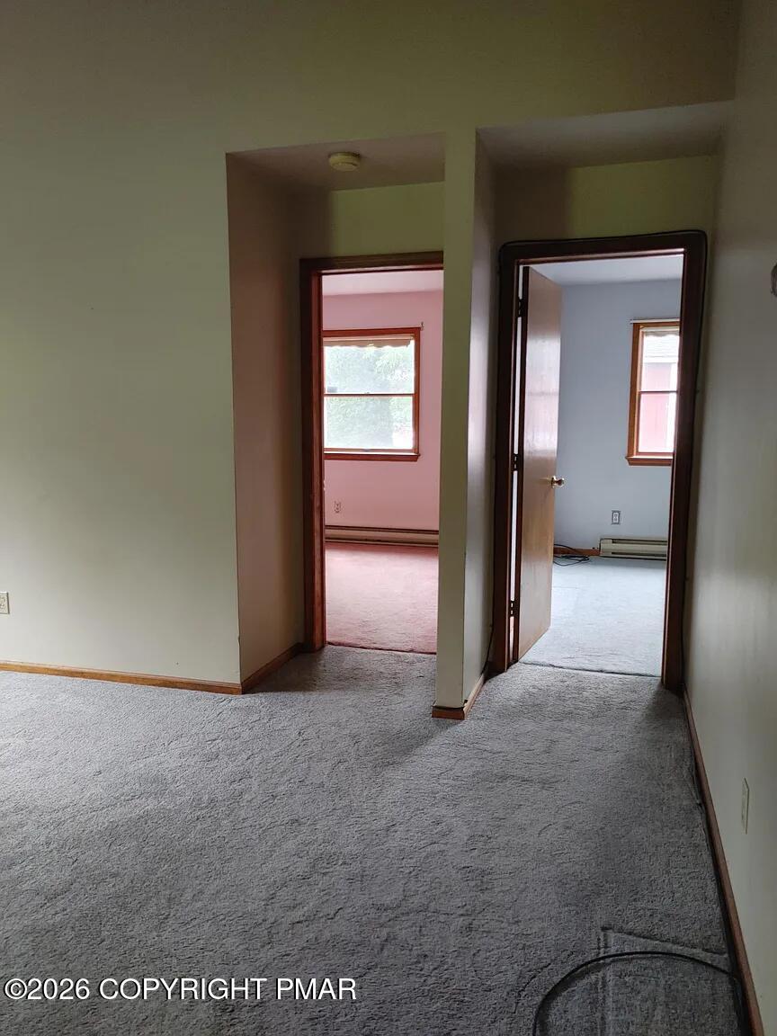 165 Old Stagecoach Road, Unit 3 Gilbert, PA 18331 - Photo 16 of 20 a view of a hallway with wooden shelves