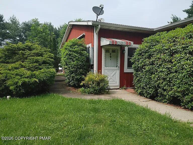165 Old Stagecoach Road, Unit 3 Gilbert, PA 18331 - Photo 2 of 20 a front view of a house with garden